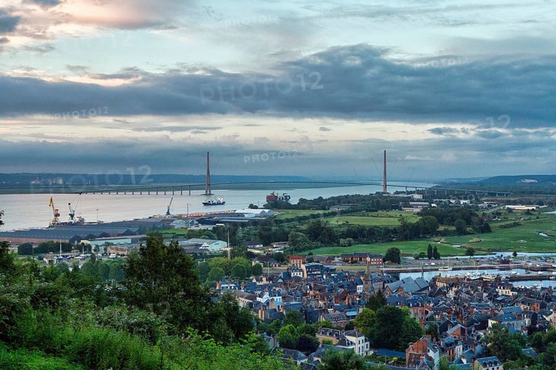 Panoramic view of the houses of the old town and the Seine with the Pont de Normandie cable-stayed bridge from Mont-Joli hill, dusk, Honfleur, Département Calvados, Basse-Normandie, France, Europe