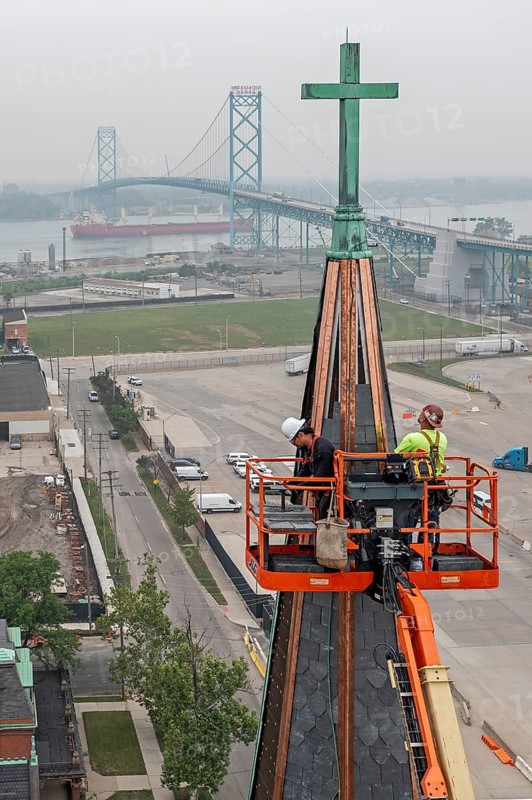 Detroit, Michigan, Workers repair the towers of the Basilica of Ste. Anne de Detroit. Ste. Anne was founded by French explorers in 1701. This building was constructed in 1886 and now serves a largely Latino population