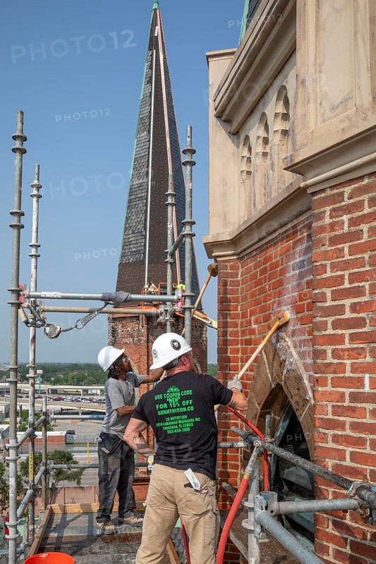 Detroit, Michigan, Kevin Driscoll (right) and Anthony Powell clean and repair the bell towers of the Basilica of Ste. Anne de Detroit. Ste. Anne was founded by French explorers in 1701. This building was constructed in 1886 and now serves a largely Latino population