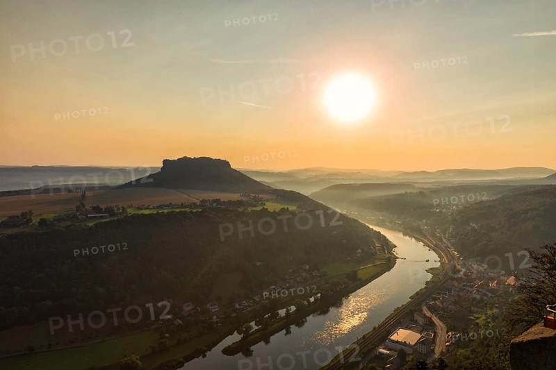 Sunrise at the Lilienstein on Königstein Fortress in Saxon Switzerland The summer heat lies as a haze in the valleys