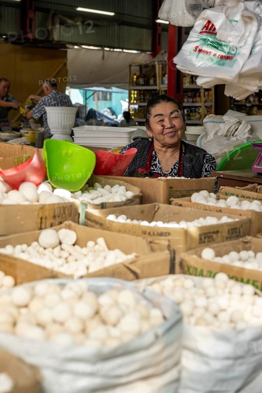 Traditional woman selling food, market stall at Osh Bazaar, Bishkek, Kyrgyzstan, Asia