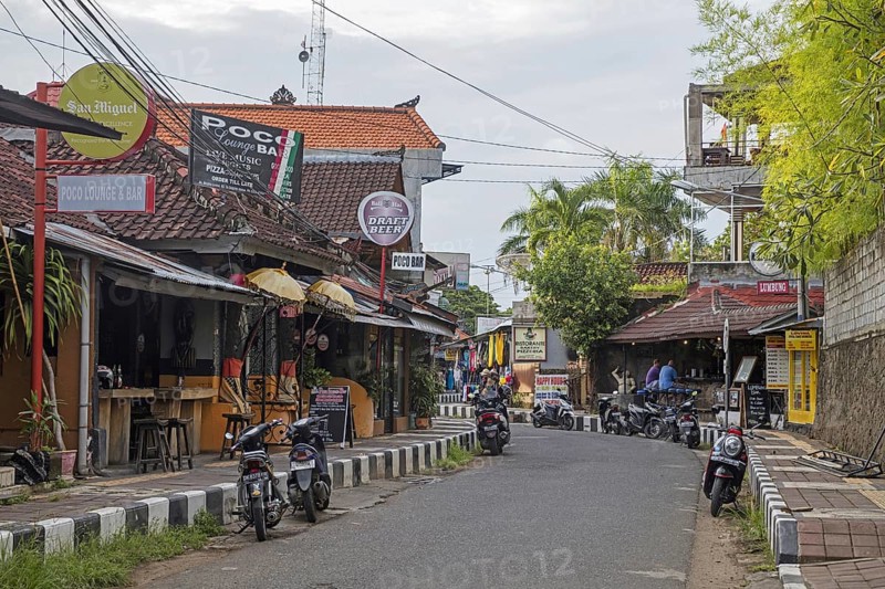 Tourists in bars along street Jalan Bina Ria in the coastal beach town Lovina, Buleleng Regency on the island Bali, Indonesia, Asia