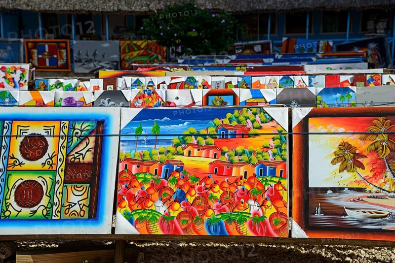 Art stall with paintings depicting tropical landscapes and seascapes, market, Bayahibe, Dominican Republic, Hispaniola, Caribbean, Central America