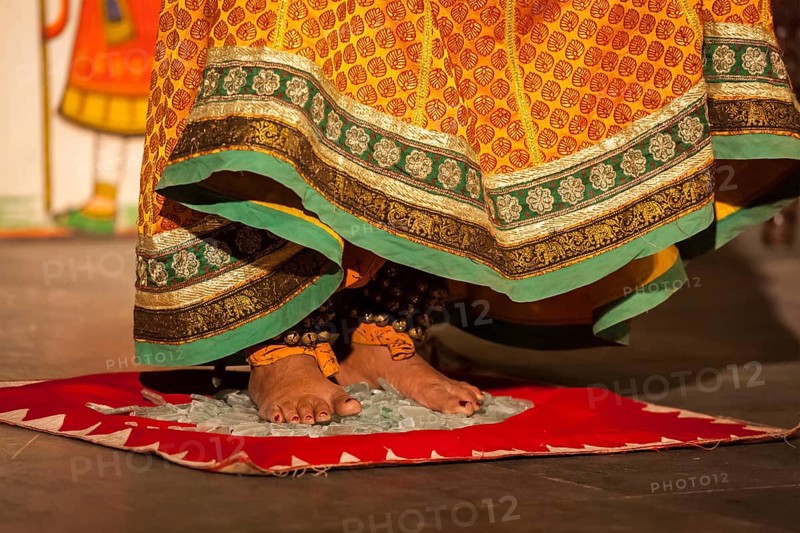 UDAIPUR, INDIA, NOVEMBER 24: Bhavai performance, folk dance of Rajasthan Performer balances number of pots as she dance on broken glass. Legs close up. November 24, 2012 in Udaipur, Rajasthan, India, Asia