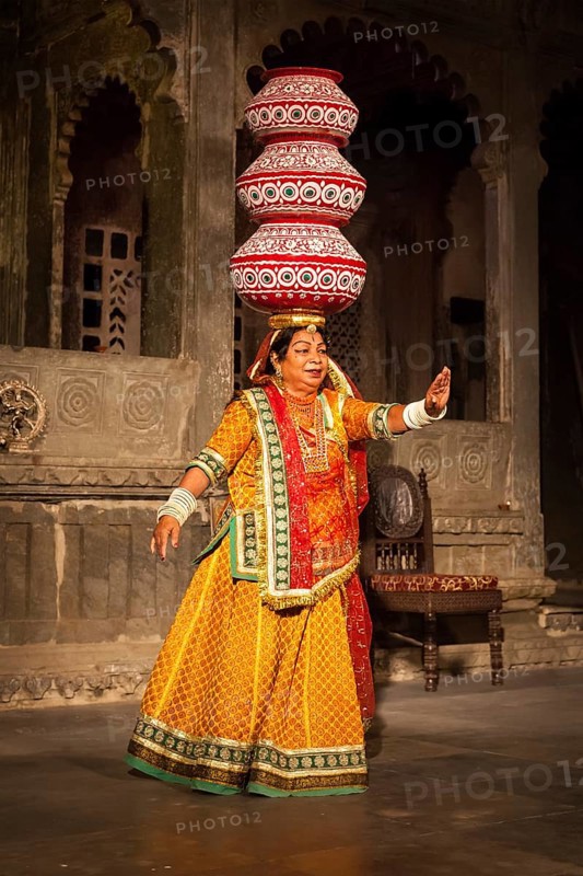 UDAIPUR, INDIA, NOVEMBER 24: Bhavai performance, famous folk dance of Rajasthan state of India. Performer balances number of earthen pots as she dance. November 24, 2012 in Udaipur, Rajasthan, India, Asia
