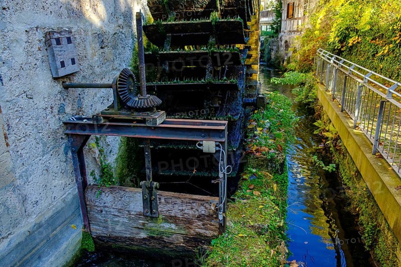Symbolic image of historical mill wheel and concept of water energy and sustainability, here using the example of the water wheel Stadtmuseum Klostermühle, Bad Urach, Swabian Alb, Baden-Württemberg, Germany, Europe