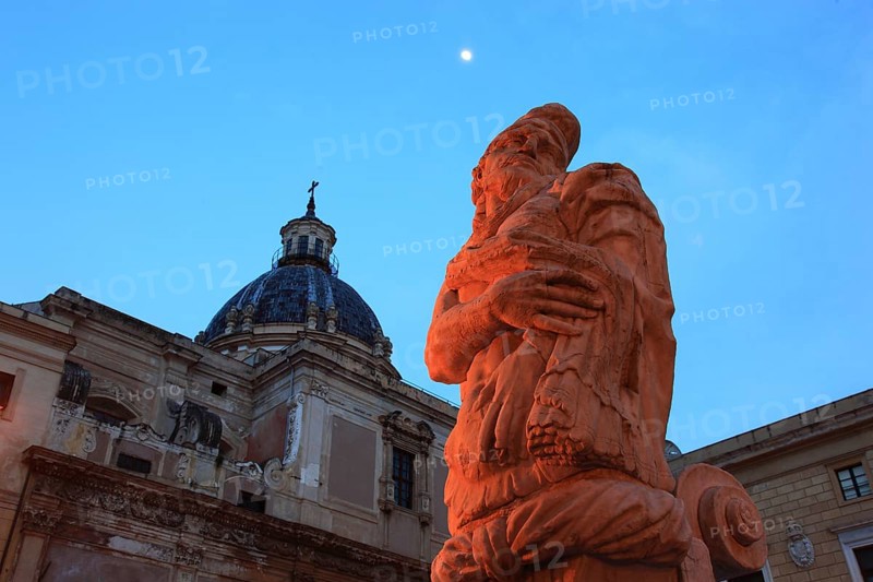In the old town of Palermo, in Piazza Pretoria, fountain figure of the Fontana Pretoria fountain and the dome of the church of Santa Caterina, Sicily, Italy, Europe