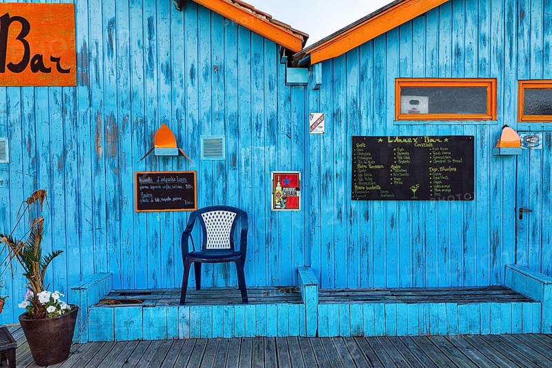 Colourful hut, wooden facade of a bar with orange sign and menu, advertising alcoholic beverages, Le Château-d'Oléron, Oleron Island, Charente Maritime Department, Nouvelle-Aquitaine, France, Europe
