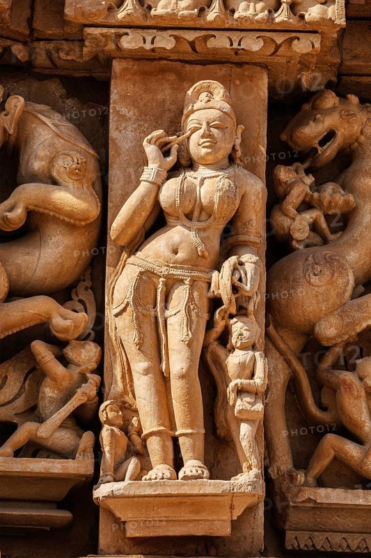 Stone carving bas relief sculpture of woman on Adinath Temple, Khajuraho, Madhya Pradesh, India, Asia
