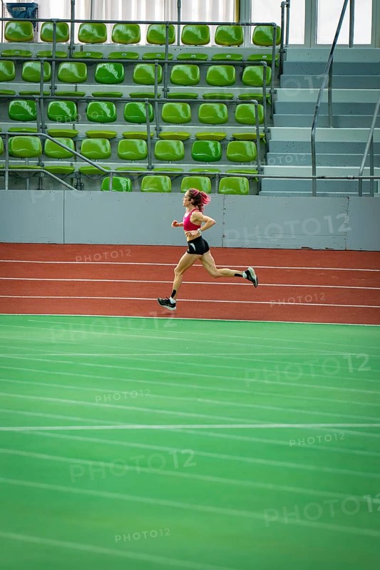 Only runner in an empty, large stadium, running track and green seats, Glaspalast, Sindelfingen