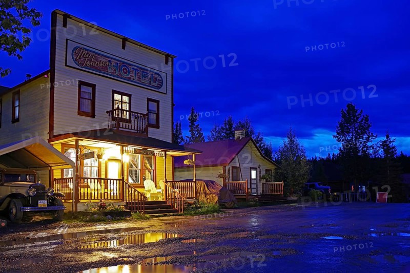 Old wooden hotel from the 1920s and a vintage car in the blue hour, abandoned mining town of McCarthy, Copper River Census, Wrangell-St. Elias National Park, Alaska, USA, North America