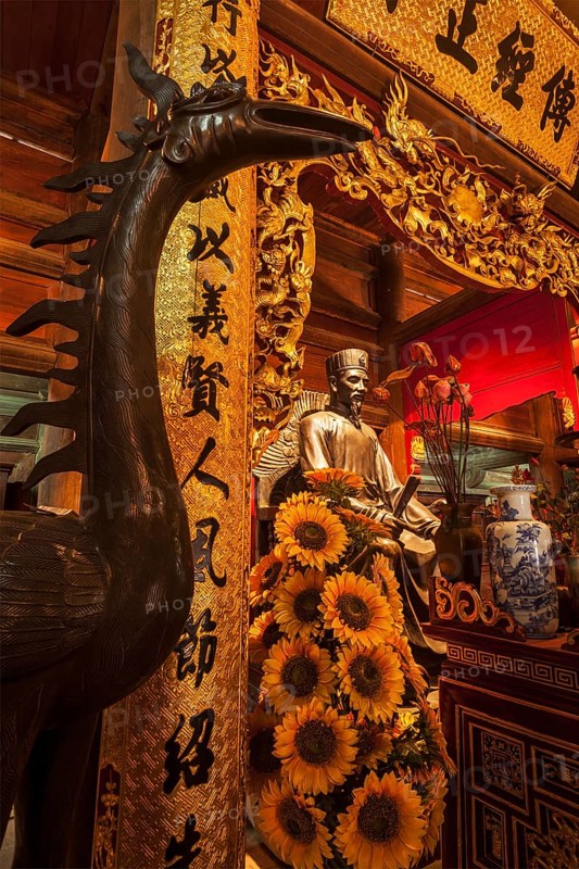 HANOI, VIETNAM, JUNE 11, 2011: Confucius statue at the Temple of Literature. This temple is dedicated to Confucius, sages and scholars