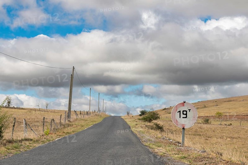 Desolate road in the countryside on a sunny summer day. Cevennes, France, Europe