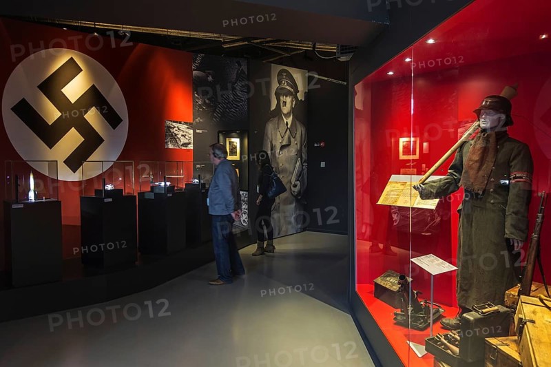 Tourists with audio guides visiting the Bastogne War Museum devoted to the Second World War Two Battle of the Bulge in the Belgian Ardennes, Belgium, Europe