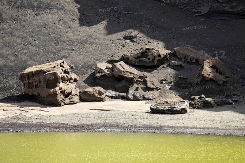 Rock formations along the green lagoon Charco de los Clicos at El Golfo, Lanzarote, Canary Islands, Spain, Europe