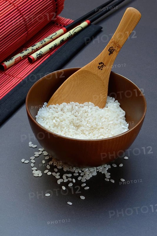 Rice, white rice in bowl with wooden ladle, uncooked