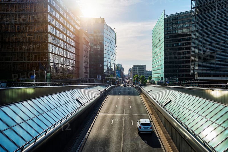 Street traffic in Brussels near European Commission building on sunset. Rue de la Loi, Bruxelles, Belgium, Europe