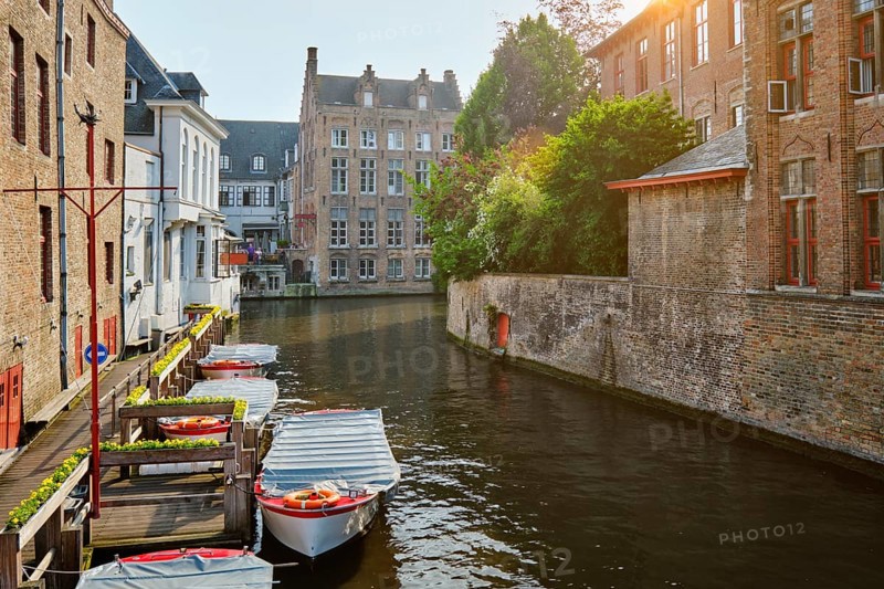 Famous place of Bruges, Rozenhoedkaai old houses along canal with tree and boats. Brugge, Belgium, Europe