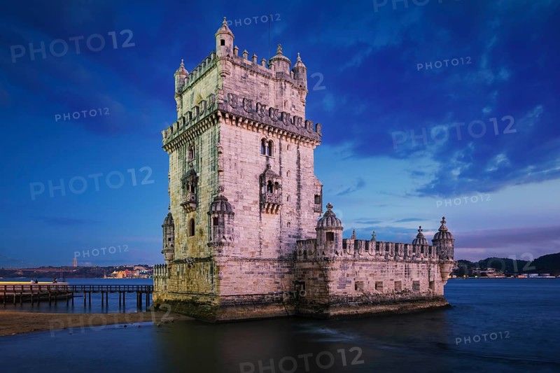 Belem Tower or Tower of St Vincent, famous tourist landmark of Lisboa and tourism attraction, on the bank of the Tagus River (Tejo) after sunset in dusk twilight with dramatic sky. Lisbon, Portugal, Europe