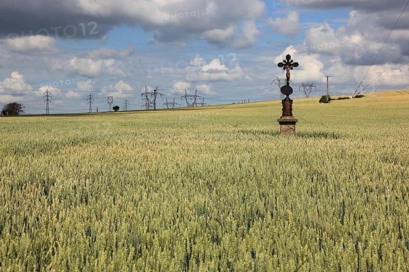 Field cross in a wheat field, in the background power lines, near Dukovany, Czech Republic, Grain field with a lonely field cross, near Dukovany, South Moravia, Kraj Vysocina, Czech Republic, Europe