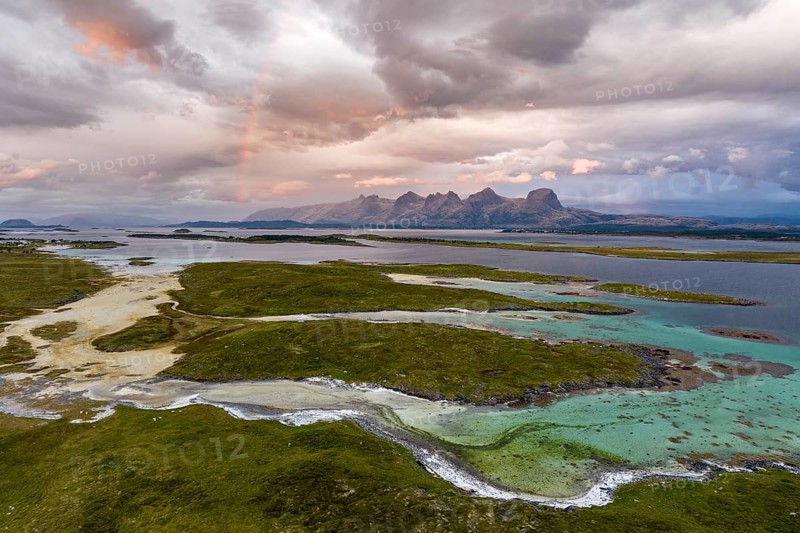 View of mountain range Seven Sisters from Herøy island, light mood with rainbow, Helgeland coast, Nordland, Norway, Europe