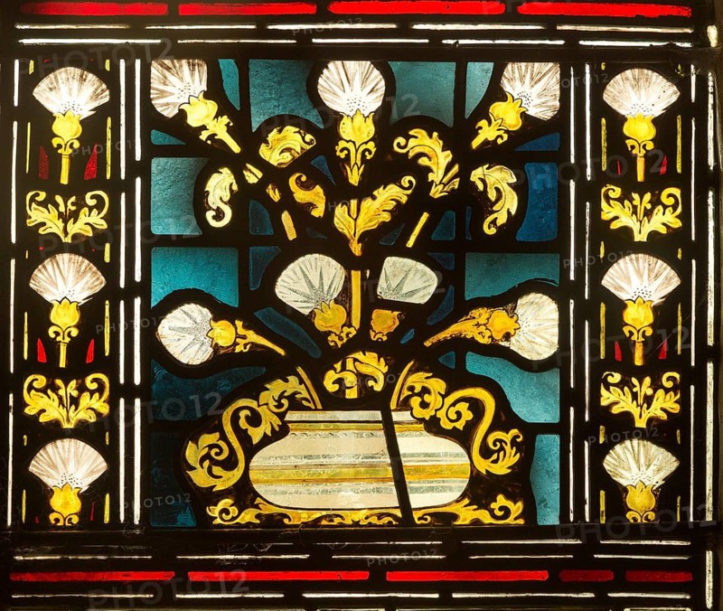 Stained glass window church of Saint John, Saxmundham, Suffolk, England, UK bunch of lilies in bowl