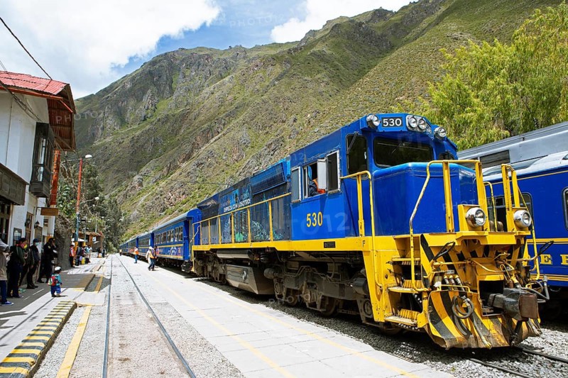 Perurail train travelling through the Andes from Ollantaytambo to Machu Picchu, here stopping at an Andean railway station, Cusco region, Peru, South America
