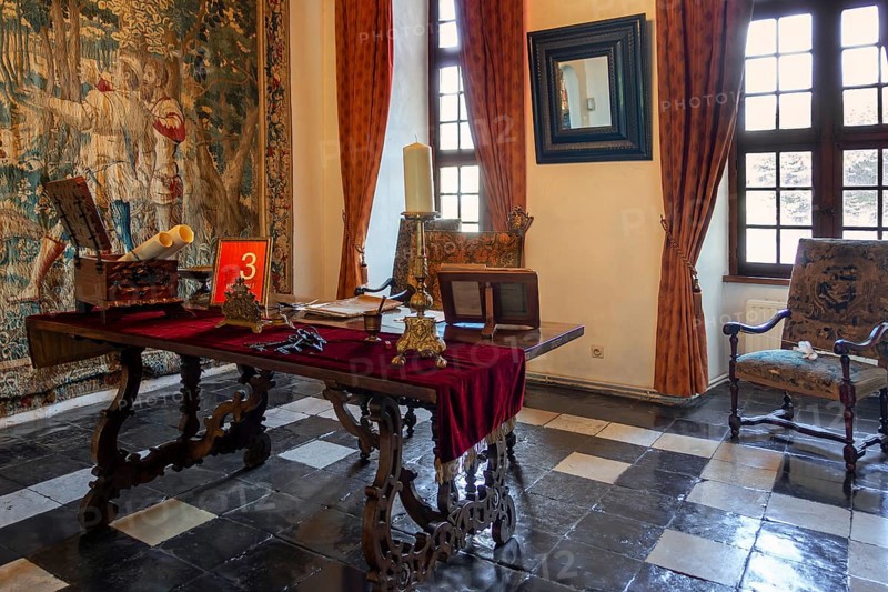 Kasteel van Laarne, interior showing room with antique furniture and tapestry inside 14th century medieval moated castle, East Flanders, Belgium, Europe