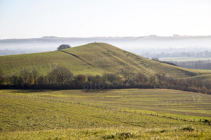 Picked Hill chalk outlier landscape misty valley floor, Vale of Pewsey, from Woodborough Hill, Wilcot, Wiltshire, England, UK