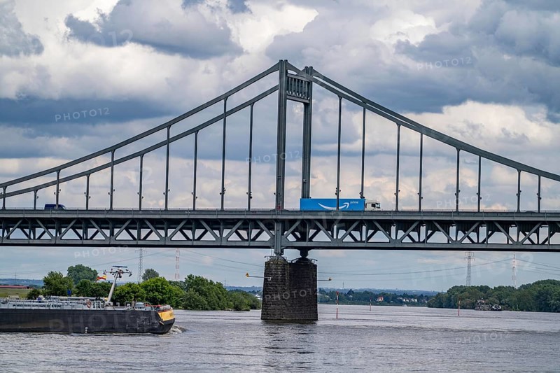 The Krefeld-Uerdingen Bridge over the Rhine, between Krefeld and Duisburg, bridle belt bridge from 1936, 858 metres long, federal road B228, shows severe bridge damage, restricted traffic on the bridge, to be replaced, cargo ship, North Rhine-Westphalia, Germany, Europe