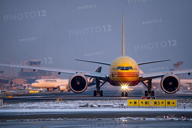 DHL, AeroLogic, Boeing 777F, on the taxiway to Runway West, Frankfurt FRA Airport, Fraport, in winter, Hesse, Germany, Europe