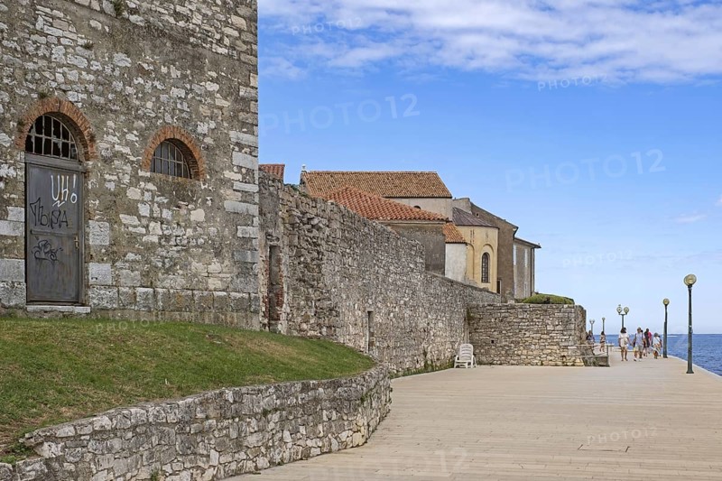 Tourists walking on promenade along ancient city wall in the town Pore?, Parenzo, seaside resort at the Adriatic Sea, Istria County, Croatia, Europe