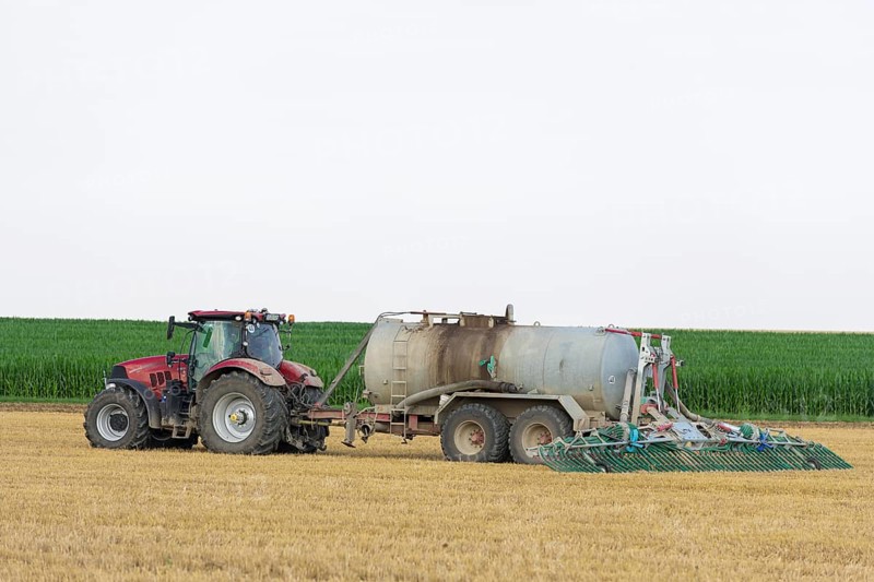 Farmer spreading liquid manure on harvested grain field, Swabian Alb, Baden-Württemberg, Germany, Europe