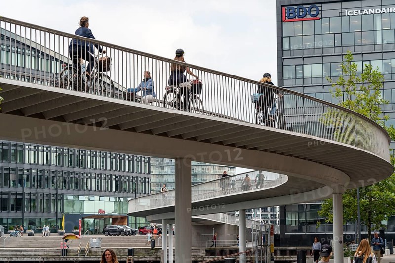 Cyclists on the Cykelslangen cycle and pedestrian bridge, at the Fisketorvet shopping centre, across the harbour, Sydhavnen, Copenhagen is considered the cycling capital of the world, 45 % of the population travel by bike, Denmark, Europe