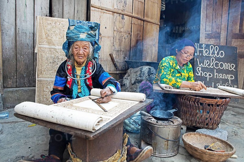 Vietnamese woman from the Hmong minority draw patterns on linen fabric, Lung Tam linen weaving mill, Ha Giang province, Vietnam, Asia