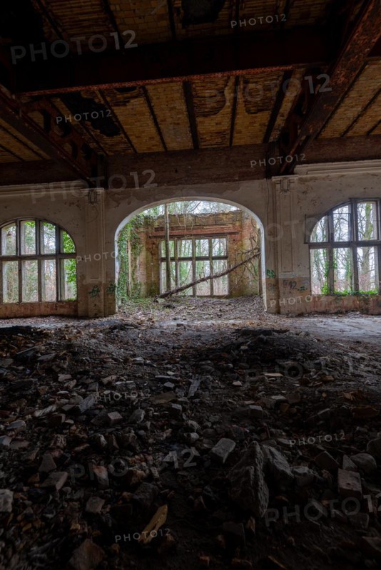 Interior view of a dilapidated building with arched windows and debris on the floor, Beelitzheilstätten, former lung sanatorium, Beelitz, Brandenburg, Germany, Europe