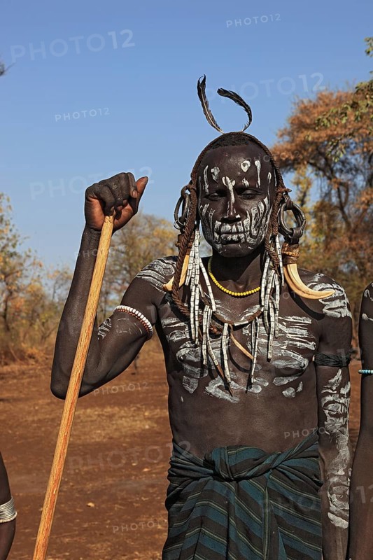 South Ethiopia, in Maco National Park, Mursi tribe, Mursi boy with painted face and headdress, Ethiopia, Africa