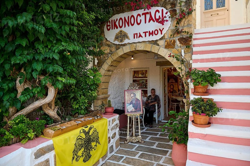 A religious shop on a Greek island, decorated with icons, plants and a railing in a historic passage, Skala, Patmos, Dodecanese, Greek Islands, Greece, Europe