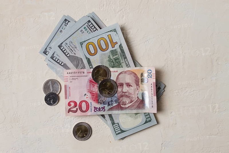 Lari, 20 GEL, Georgian monetary currency, with dollars, banknotes, top view, no people, on the table