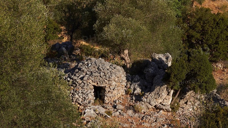 Koumas, traditional stone shelter for shepherds, an old stone ruin nestled among trees in a green environment, Lefka Ori, White Mountains, mountain massif, west, Crete, Greece, Europe