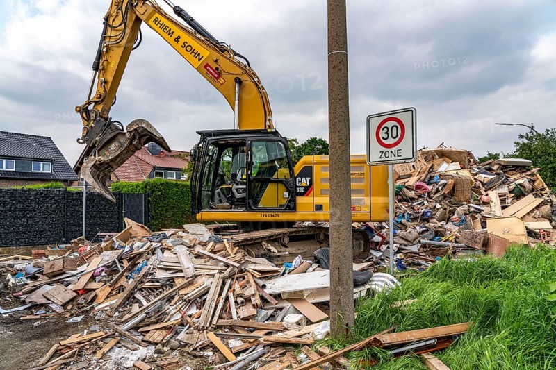 Flood on the Erft, on the outskirts of the Bliesheim district, Erftstadt, the household rubbish was stored, which was taken from the flats and houses of the village after the flooding of the village, from here it is taken by lorry to landfills, North Rhine-Westphalia, Germany, Europe