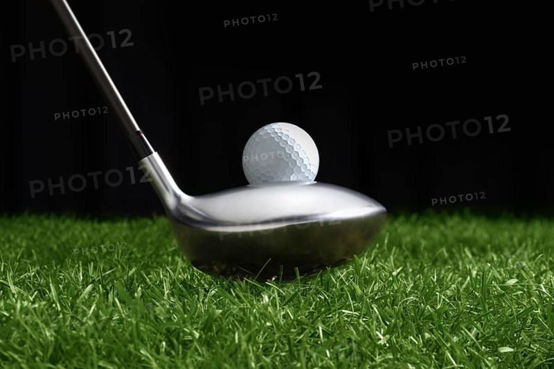 Golf club, golf ball on grass