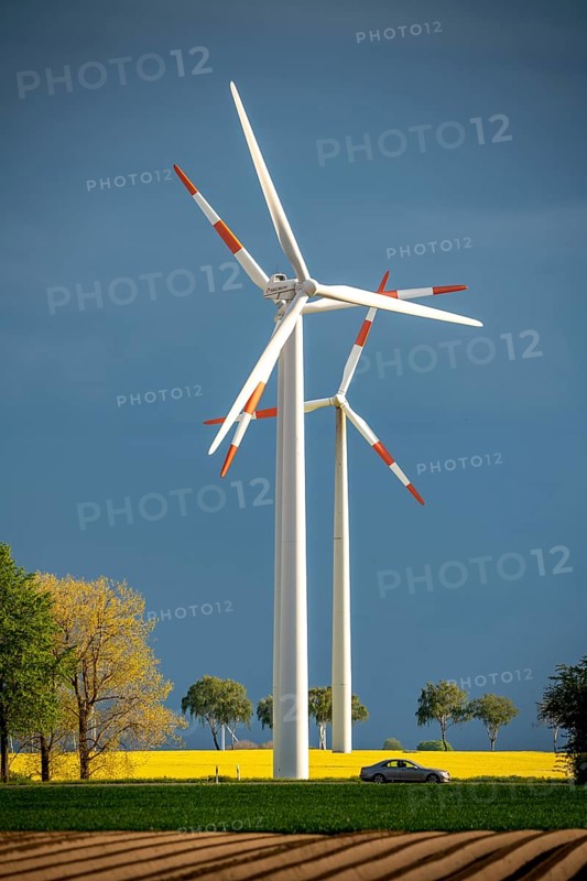 Wind turbines on a rape field, dark rain clouds, in the Rhenish lignite mining area, near Erkelenz-Holzweiler
