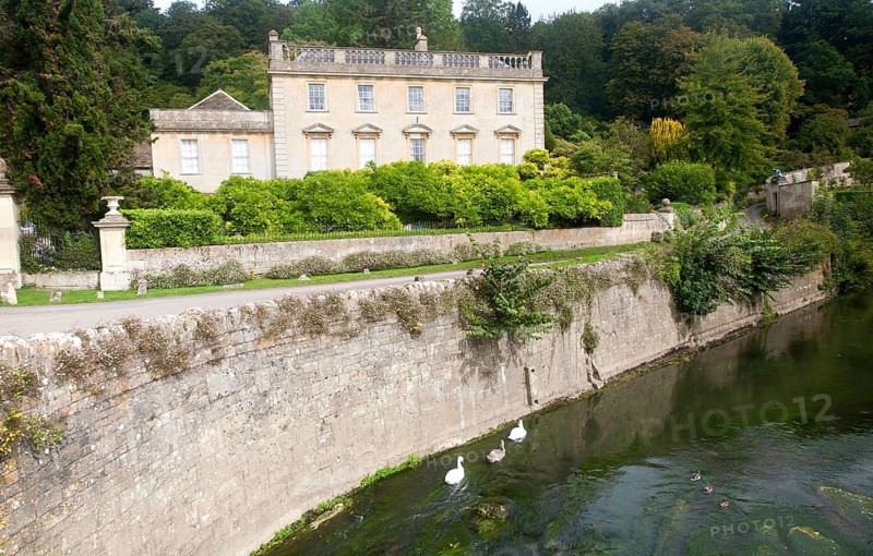 River Frome and the classical Georgian facade of Iford Manor, near Freshford, Wiltshire, England, UK