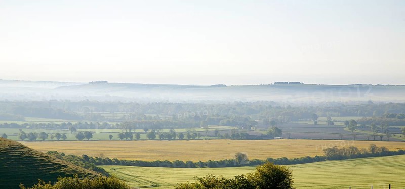 Early morning ground fog lying over fields in the Vale of Pewsey, near Alton Barnes, Wiltshire, England, United Kingdom, Europe