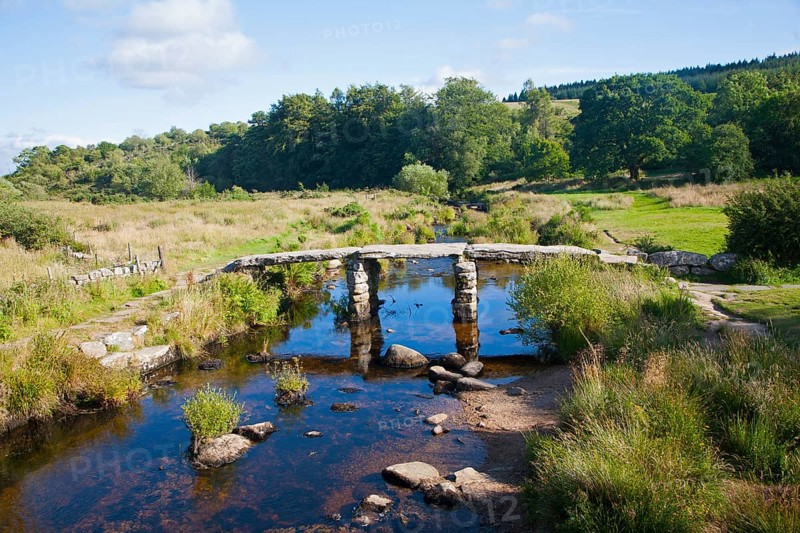 Historic medieval Clapper Bridge at Postbridge, Dartmoor national park, Devon, England crossing the East Dart river