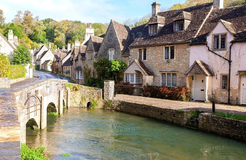 Bybrook River running past stone cottages in Castle Combe, Wiltshire, England, UK claimed to be England's prettiest village