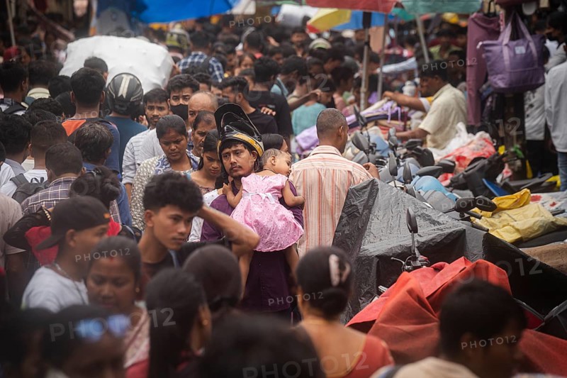 A person with his child in the crowd of people to shop at a street market ahead of Durga Puja festival on October 7, 2024 in Guwahati, India. Shopping ahead of Durga Puja is a major event, as people prepare for the celebration