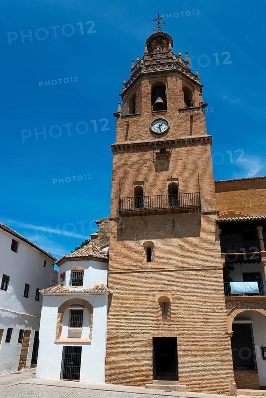 Historic brick church tower with clock in front of a clear blue sky in a sunny old town, church, once a Moorish mosque, Iglesia de Santa Maria la Mayor, old town, Ronda, Malaga, Málaga province, Andalusia, Spain, Europe