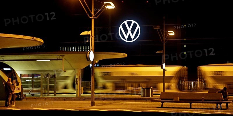 Wolfsburg main station at night with illuminated VW logo at the Volkswagen AG main plant, Lower Saxony, Germany, Europe